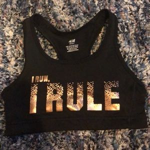 Black bra, “I run, I rule” in gold lettering